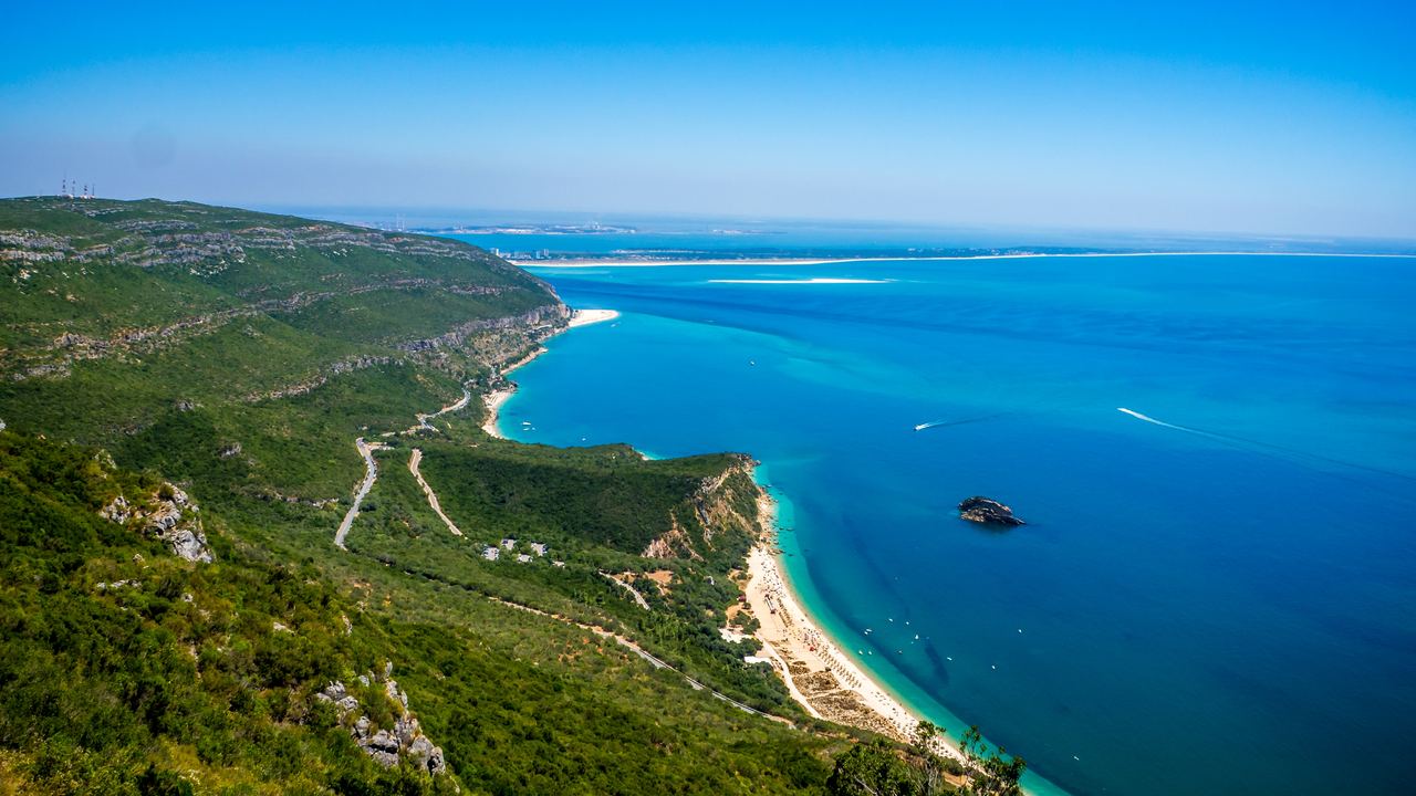 Aerial view of a long sandy bay below the Serra da Arrábida near Setúbal, Portugal