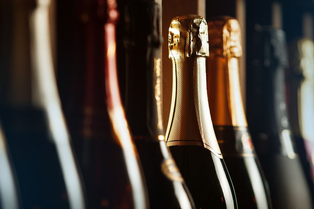 Foil-capped bottle necks of sparkling wine in close-up