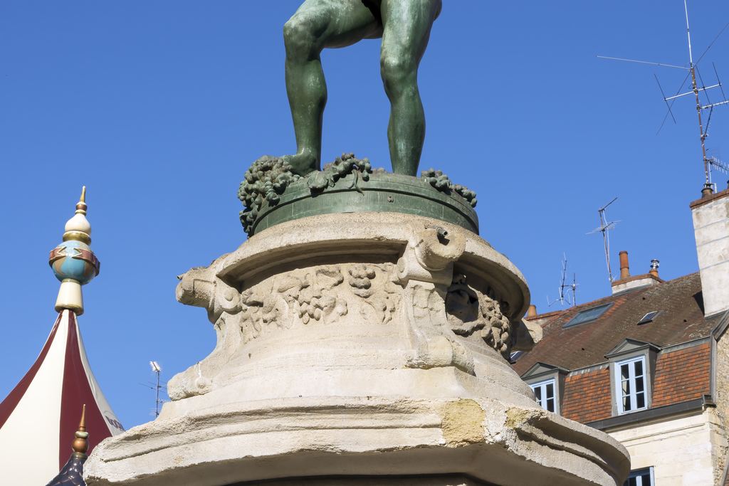 Bronze statue of a grape-treader on a fountain in Place François-Rude, Dijon