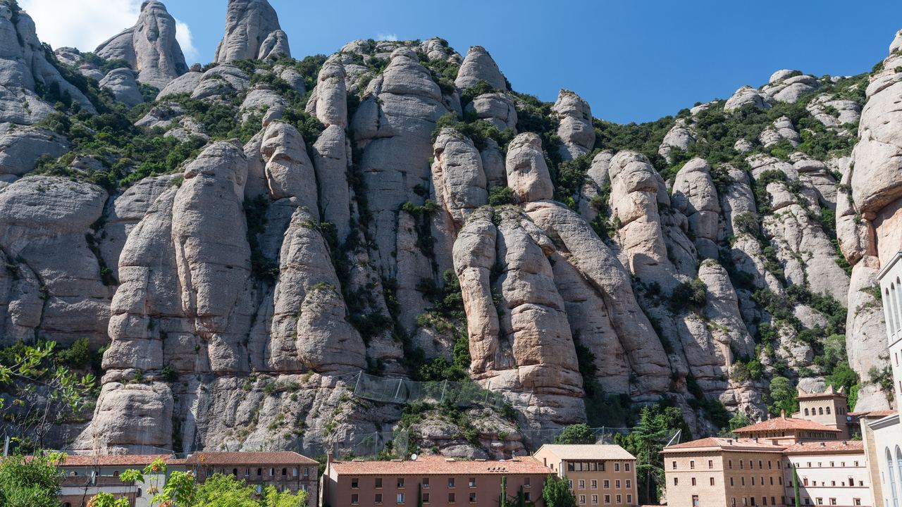 Monastery buildings below the serrated rock walls of Montserrat, Catalonia