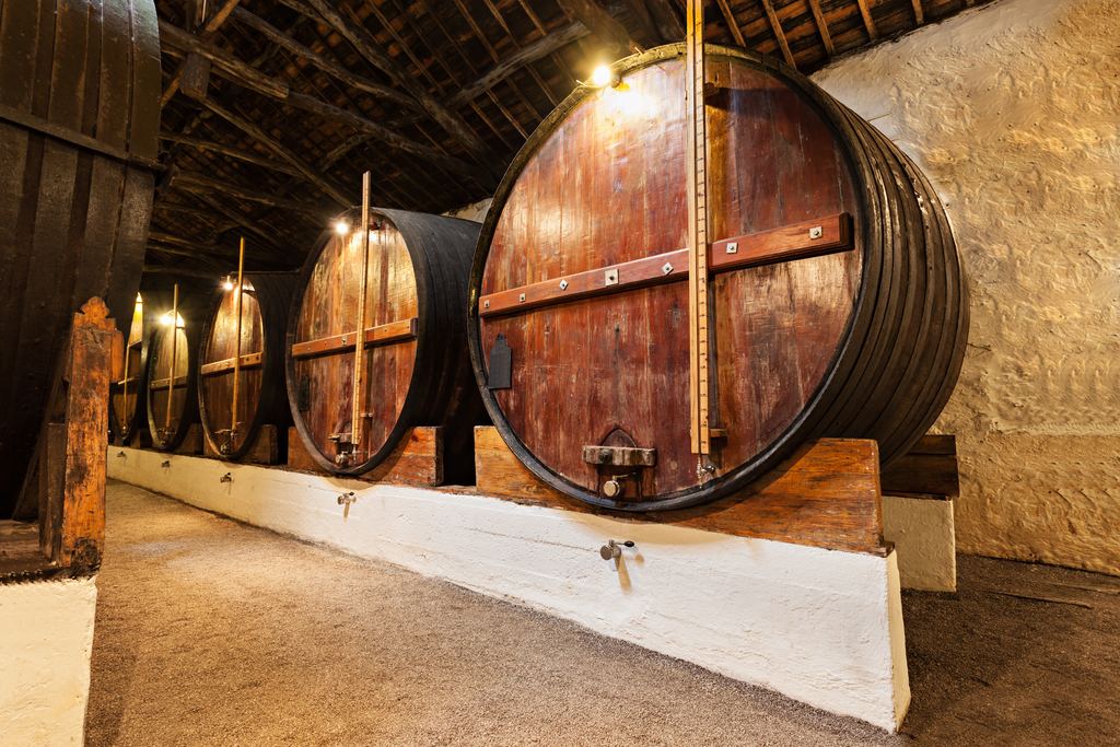 Large oak vats on wooden cradles in a port wine cellar in Porto