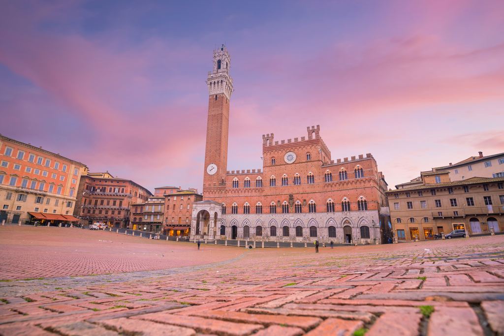 Torre del Mangia and Palazzo Pubblico on Piazza del Campo in Siena at twilight