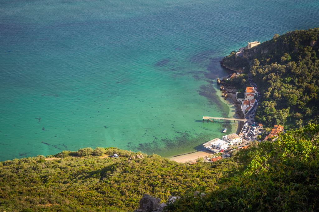 Small harbour and pier at Portinho da Arrábida seen from above, turquoise water, Portugal
