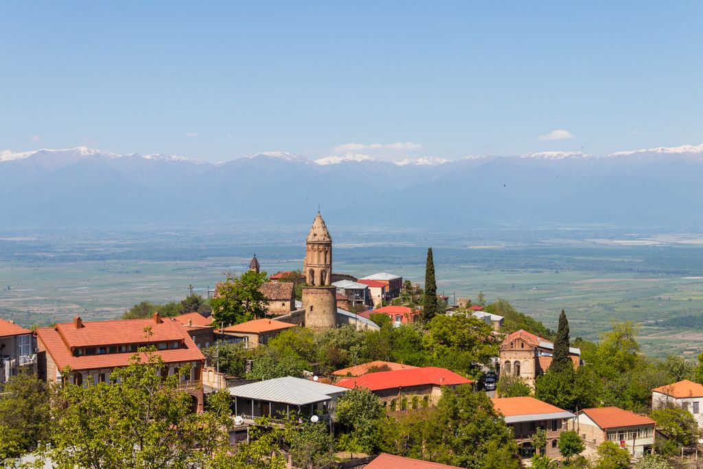 Red-roofed town of Sighnaghi above the Alazani Valley in Kakheti, Georgia, with the snow-capped Caucasus on the horizon