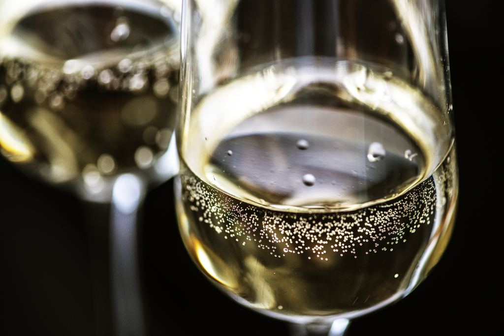 Close-up of two flutes of sparkling wine with rising bubbles