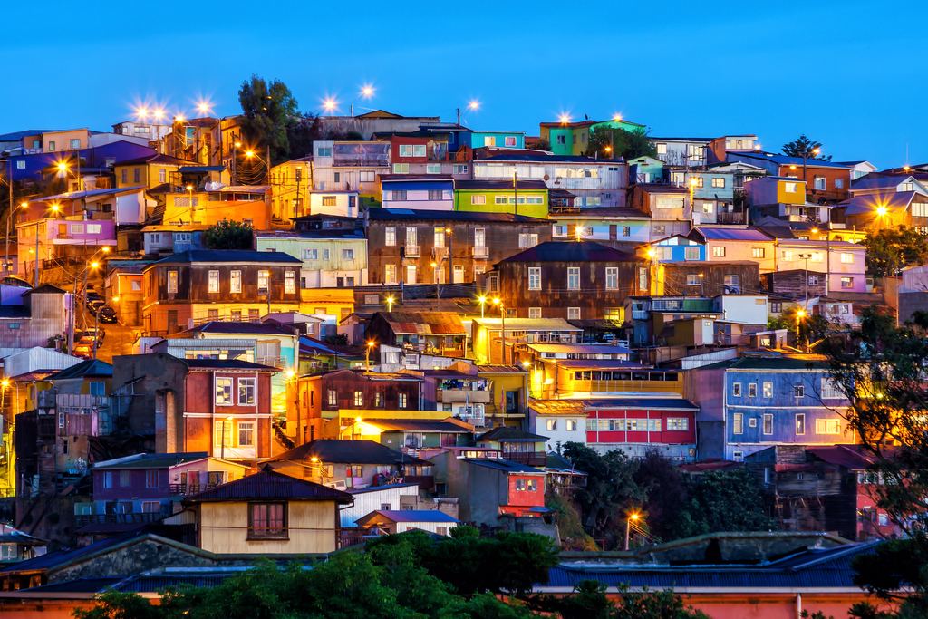 Lit-up houses on a Valparaíso hillside at dusk