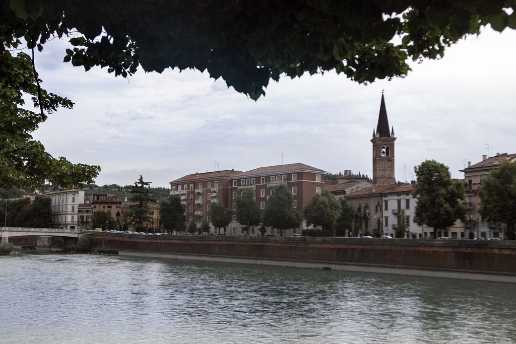 Verona historic centre on the Adige river under a cloudy sky