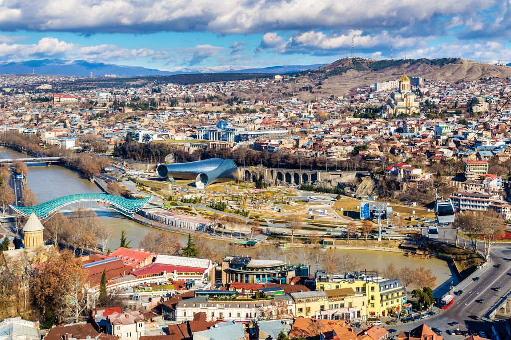 View over Tbilisi from Narikala Fortress, with the Kura river, the Bridge of Peace and Sameba Cathedral in the distance