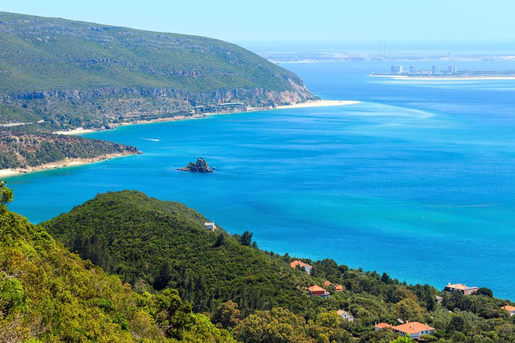 Green hills of the Serra da Arrábida above the sea with the Setúbal estuary beyond, Portugal